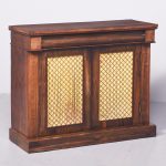 Neat size rosewood Regency cabinet with brass grill doors