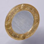Decorative embossed brass Glasgow-style circular wall mirror