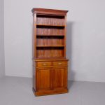 Late Victorian, tall mahogany two-part open bookcase with drawers.
