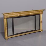 Neat-sized, Regency period gilded triptych overmantel mirror with acanthus decorated columns.