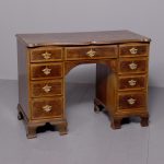 George II style crossbanded figured walnut kneehole desk with engraved brass handle